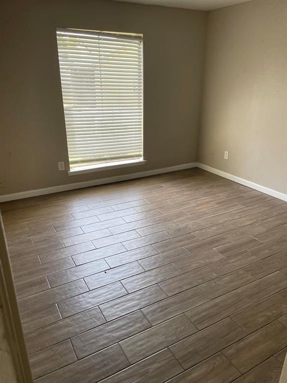 5625 Antoine Dr Unit 1406, Houston, TX 77091 - spare room featuring plenty of natural light and dark wood finished floors