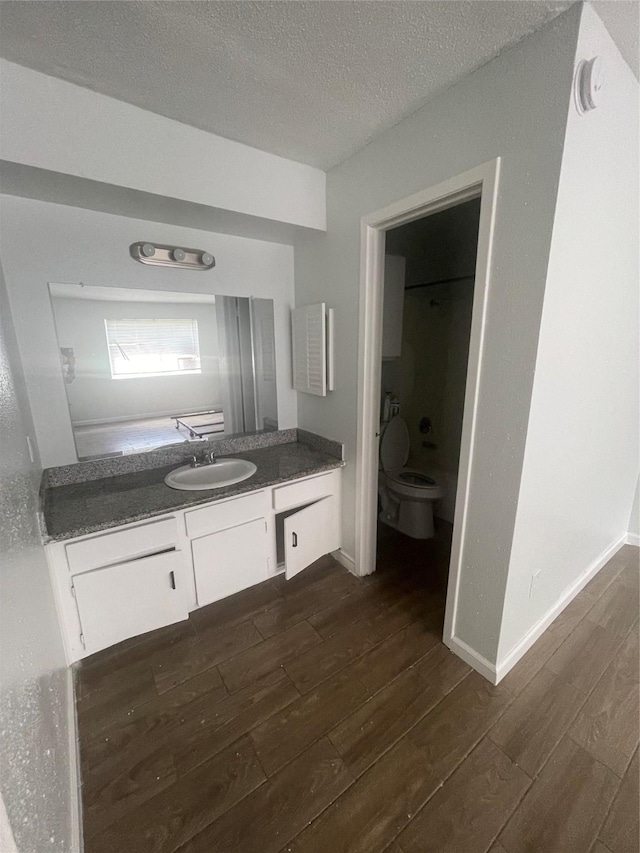5625 Antoine Dr Unit 1406, Houston, TX 77091 - bathroom featuring wood finished floors, vanity, and a textured ceiling