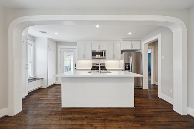 5001 Farmer St, Houston, TX 77020 - kitchen with appliances with stainless steel finishes, light countertops, dark wood-type flooring, white cabinets, and recessed lighting