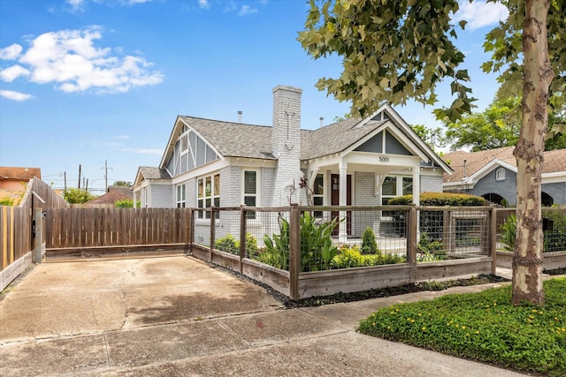 5001 Farmer St, Houston, TX 77020 - view of front facade with roof with shingles, a chimney, brick siding, and a porch