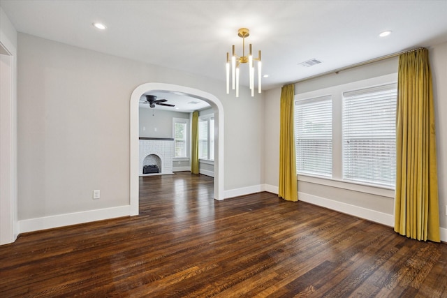 5001 Farmer St, Houston, TX 77020 - unfurnished living room with dark wood-style flooring, ceiling fan, a fireplace, arched walkways, and recessed lighting