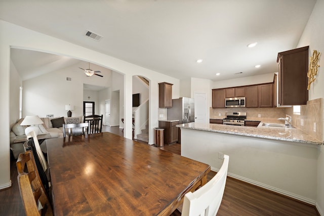 6406 Shadowbrook Hollow Trl, Katy, TX 77493 - dining room with ceiling fan, stairway, dark wood-style floors, vaulted ceiling, and arched walkways