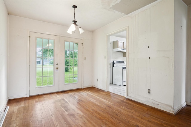 8510 Montridge Dr, Houston, TX 77055 - unfurnished dining area with wood finished floors, french doors, and a chandelier