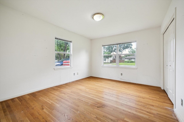 8510 Montridge Dr, Houston, TX 77055 - unfurnished bedroom with light wood finished floors, multiple windows, and a closet