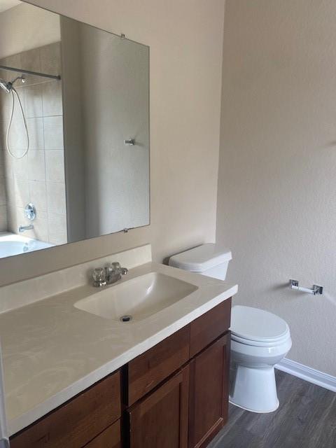 16707 Libson Falls Dr, Houston, TX 77095 - bathroom featuring vanity, wood finished floors, and shower / bathtub combination