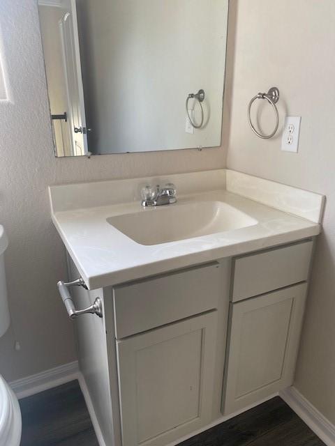 16707 Libson Falls Dr, Houston, TX 77095 - half bathroom featuring vanity and wood finished floors
