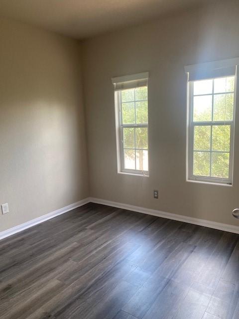 16707 Libson Falls Dr, Houston, TX 77095 - empty room featuring dark wood-type flooring and baseboards