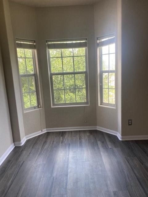 16707 Libson Falls Dr, Houston, TX 77095 - empty room featuring dark wood-type flooring and baseboards