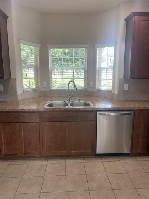 16707 Libson Falls Dr, Houston, TX 77095 - kitchen featuring stainless steel dishwasher, tasteful backsplash, light stone counters, and light tile patterned floors