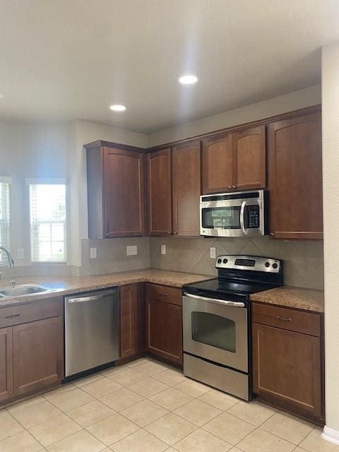 16707 Libson Falls Dr, Houston, TX 77095 - kitchen featuring stainless steel appliances, backsplash, light tile patterned floors, and recessed lighting