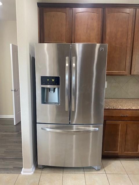 16707 Libson Falls Dr, Houston, TX 77095 - kitchen view of stainless steel refrigerator with ice dispenser and light stone countertops