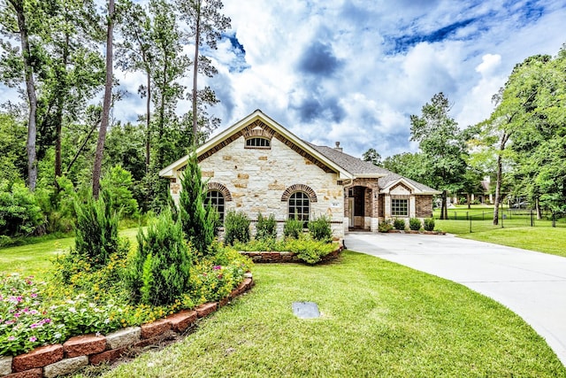 104 Drexal Dr, Huntsville, TX 77340 - french country home with stone siding and driveway