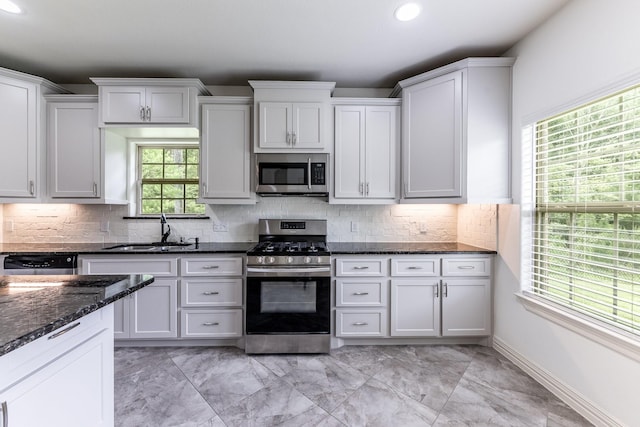 104 Drexal Dr, Huntsville, TX 77340 - kitchen with stainless steel appliances, recessed lighting, dark stone counters, tasteful backsplash, and light marble finish flooring