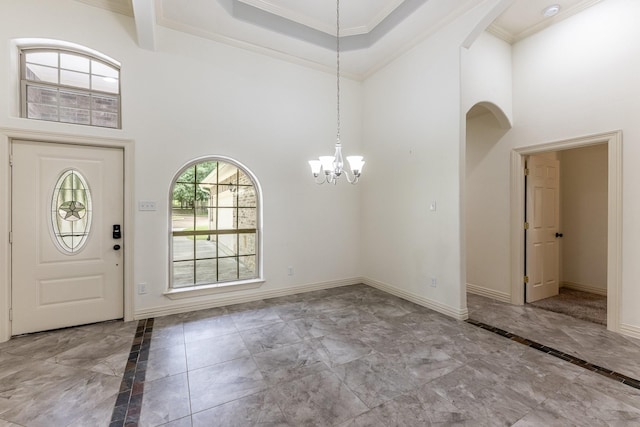 104 Drexal Dr, Huntsville, TX 77340 - entryway featuring a towering ceiling, marble finish floors, a chandelier, ornamental molding, and arched walkways