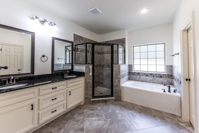 104 Drexal Dr, Huntsville, TX 77340 - bathroom featuring a garden tub, double vanity, and a stall shower