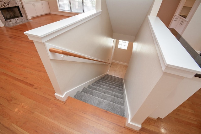 9703 Riddlewood Ln, Houston, TX 77025 - stairs with wood finished floors and a fireplace with flush hearth