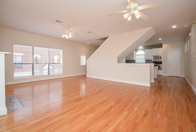 9703 Riddlewood Ln, Houston, TX 77025 - unfurnished living room featuring ceiling fan, light wood finished floors, and recessed lighting