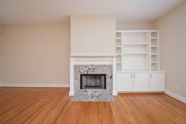 9703 Riddlewood Ln, Houston, TX 77025 - unfurnished living room with light wood finished floors and a tiled fireplace