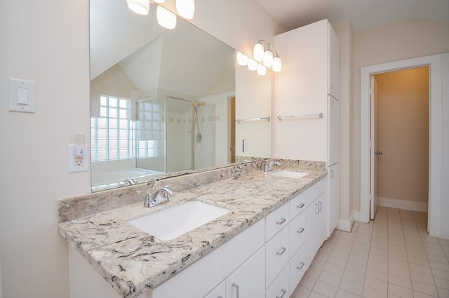 9703 Riddlewood Ln, Houston, TX 77025 - bathroom featuring double vanity, a stall shower, tile patterned floors, a bath, and vaulted ceiling