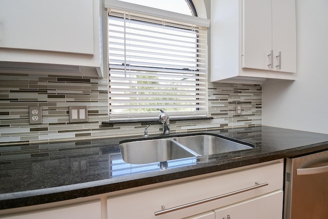 9703 Riddlewood Ln, Houston, TX 77025 - kitchen with stainless steel dishwasher, white cabinets, tasteful backsplash, and healthy amount of natural light