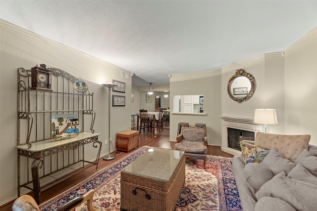 4643 Wild Indigo St Unit 416, Houston, TX 77027 - living room with crown molding, wood finished floors, and a fireplace