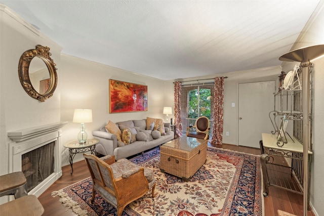 4643 Wild Indigo St Unit 416, Houston, TX 77027 - living area featuring a fireplace, wood finished floors, and crown molding