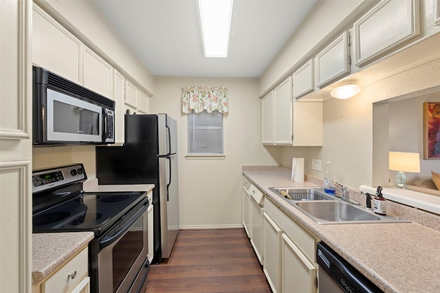 4643 Wild Indigo St Unit 416, Houston, TX 77027 - kitchen featuring stainless steel appliances, dark wood-type flooring, light countertops, and white cabinetry