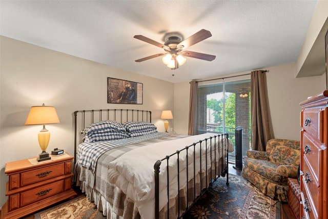4643 Wild Indigo St Unit 416, Houston, TX 77027 - bedroom with access to outside, ceiling fan, and a textured ceiling
