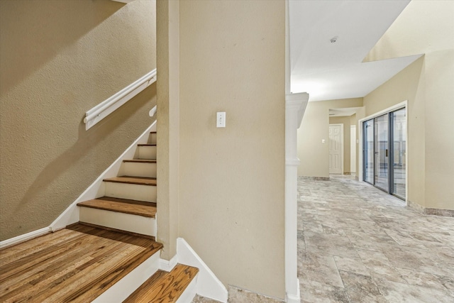 7447 Cambridge St Unit 15, Houston, TX 77054 - staircase with stone finish floors and baseboards