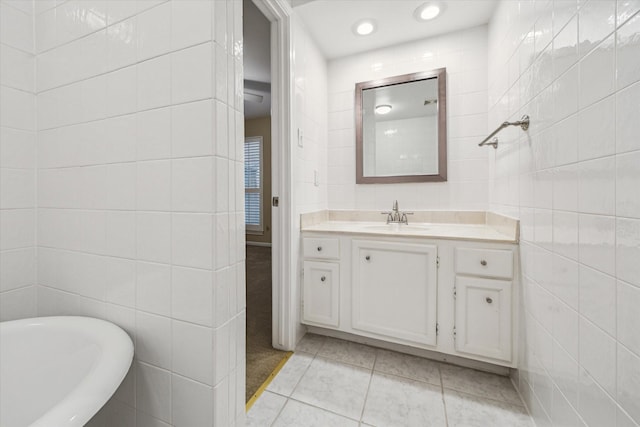 7447 Cambridge St Unit 15, Houston, TX 77054 - bathroom with tile walls, tile patterned floors, vanity, a soaking tub, and recessed lighting