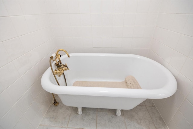7447 Cambridge St Unit 15, Houston, TX 77054 - full bath with tile walls, a freestanding bath, and tile patterned floors