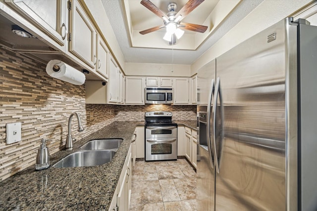 7447 Cambridge St Unit 15, Houston, TX 77054 - kitchen with stainless steel appliances, decorative backsplash, ceiling fan, dark stone counters, and white cabinets