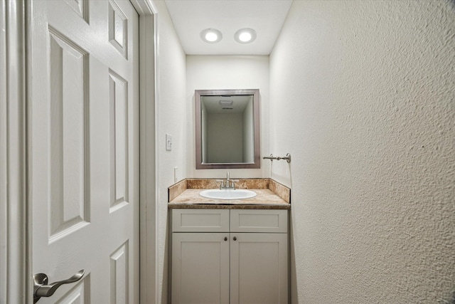 7447 Cambridge St Unit 15, Houston, TX 77054 - bathroom with vanity and a textured wall