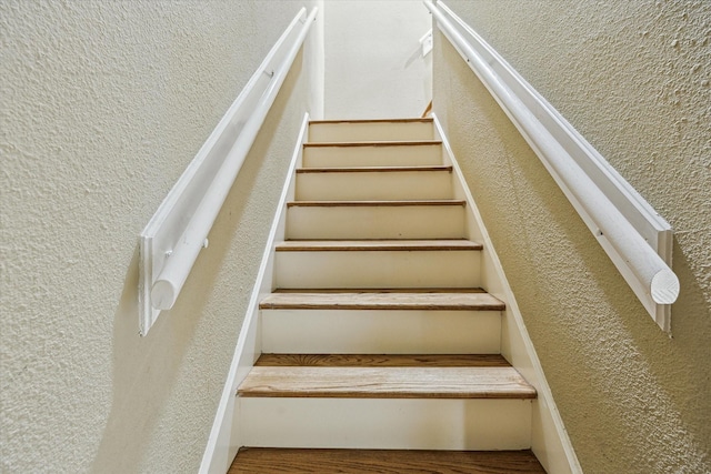 7447 Cambridge St Unit 15, Houston, TX 77054 - staircase featuring a textured wall and wood finished floors