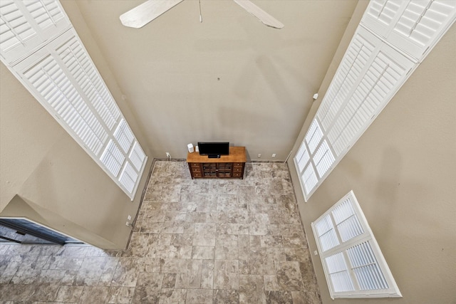 7447 Cambridge St Unit 15, Houston, TX 77054 - unfurnished living room featuring a towering ceiling and a ceiling fan