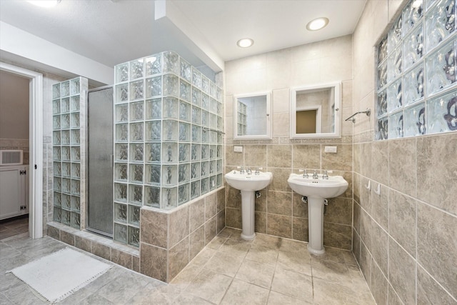 7447 Cambridge St Unit 15, Houston, TX 77054 - full bath with a shower stall, tile walls, and tile patterned floors
