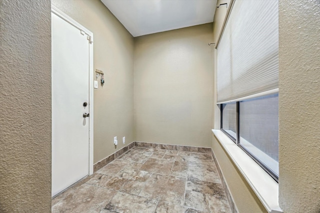 7447 Cambridge St Unit 15, Houston, TX 77054 - empty room featuring stone finish flooring and baseboards