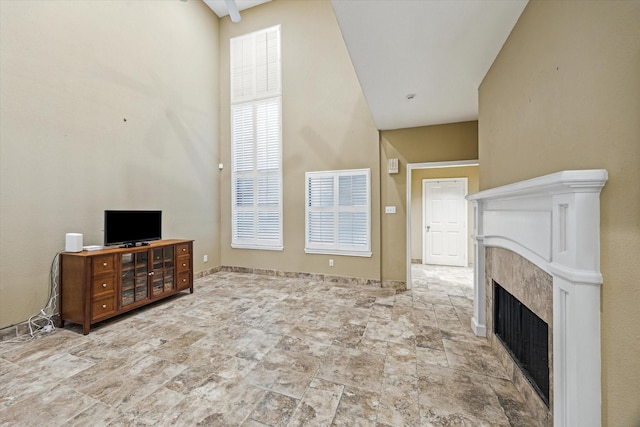 7447 Cambridge St Unit 15, Houston, TX 77054 - unfurnished living room with a high ceiling, a premium fireplace, and stone finish floors