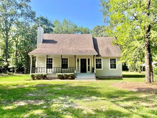 387 Hackberry Dr, Onalaska, TX 77360 - view of front of property with covered porch, a chimney, a front yard, and a shingled roof
