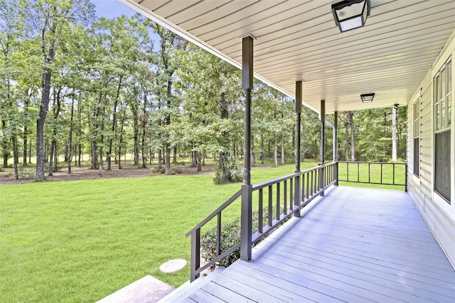 387 Hackberry Dr, Onalaska, TX 77360 - wooden porch with a lawn and view of wooded area