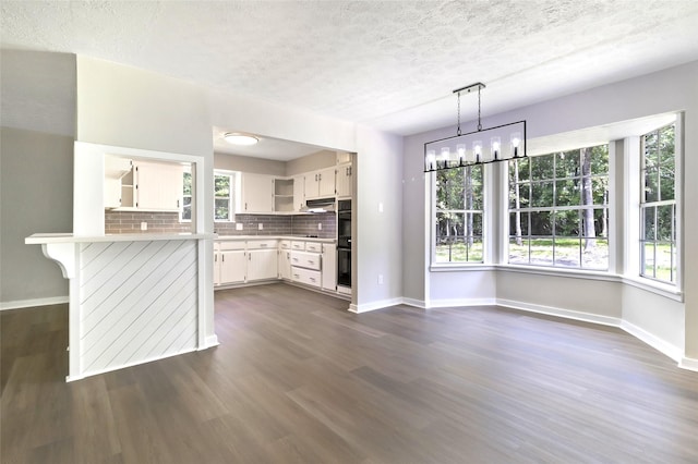 387 Hackberry Dr, Onalaska, TX 77360 - kitchen featuring open shelves, a textured ceiling, light countertops, white cabinetry, and dark wood finished floors