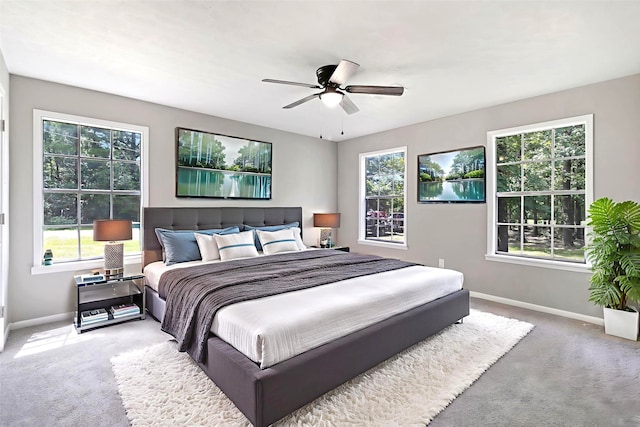 387 Hackberry Dr, Onalaska, TX 77360 - carpeted bedroom featuring multiple windows and ceiling fan
