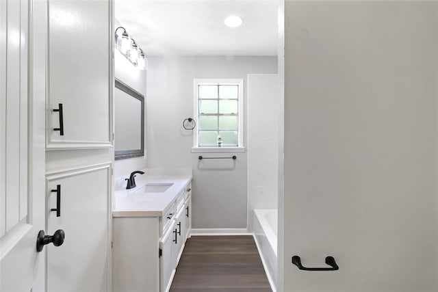 387 Hackberry Dr, Onalaska, TX 77360 - full bath featuring vanity and wood finished floors