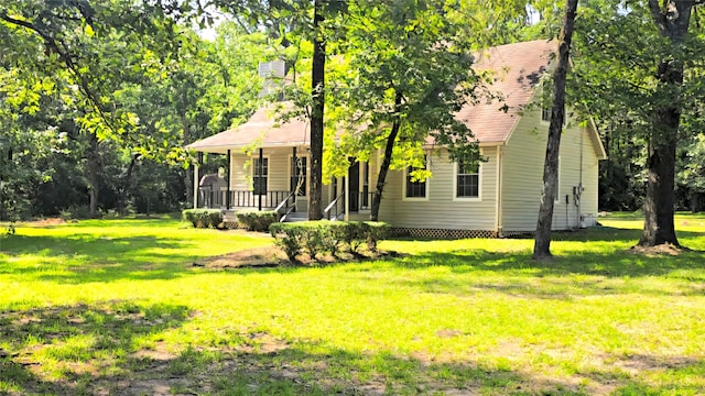 387 Hackberry Dr, Onalaska, TX 77360 - view of front of home featuring a porch and a front lawn