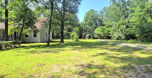 387 Hackberry Dr, Onalaska, TX 77360 - view of grassy yard with a detached carport