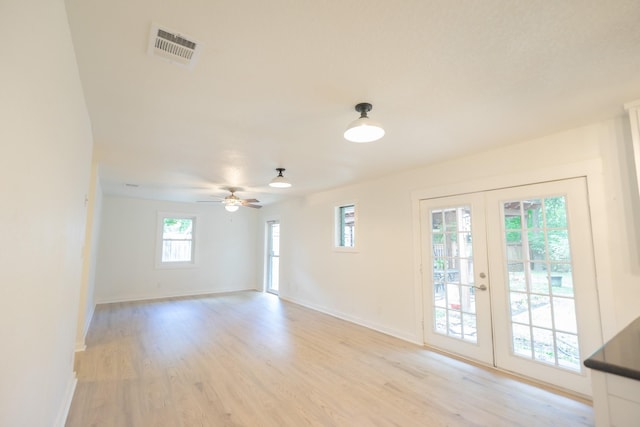 1025 Hathaway Ln, Marque, TX 77568 - spare room featuring french doors, light wood-type flooring, and ceiling fan