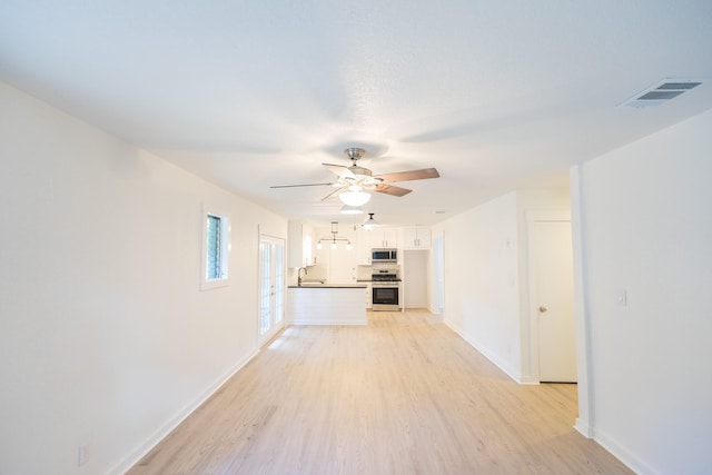 1025 Hathaway Ln, Marque, TX 77568 - unfurnished living room with light wood-style floors and a ceiling fan