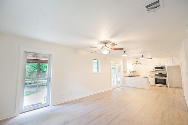 1025 Hathaway Ln, Marque, TX 77568 - unfurnished living room with light wood-type flooring and ceiling fan