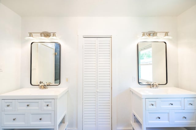 1025 Hathaway Ln, Marque, TX 77568 - bathroom featuring two vanities and a closet