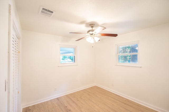 1025 Hathaway Ln, Marque, TX 77568 - unfurnished bedroom with multiple windows, light wood-type flooring, a ceiling fan, and a closet